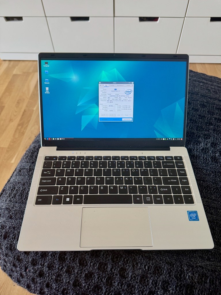 a silver laptop with a linux desktop